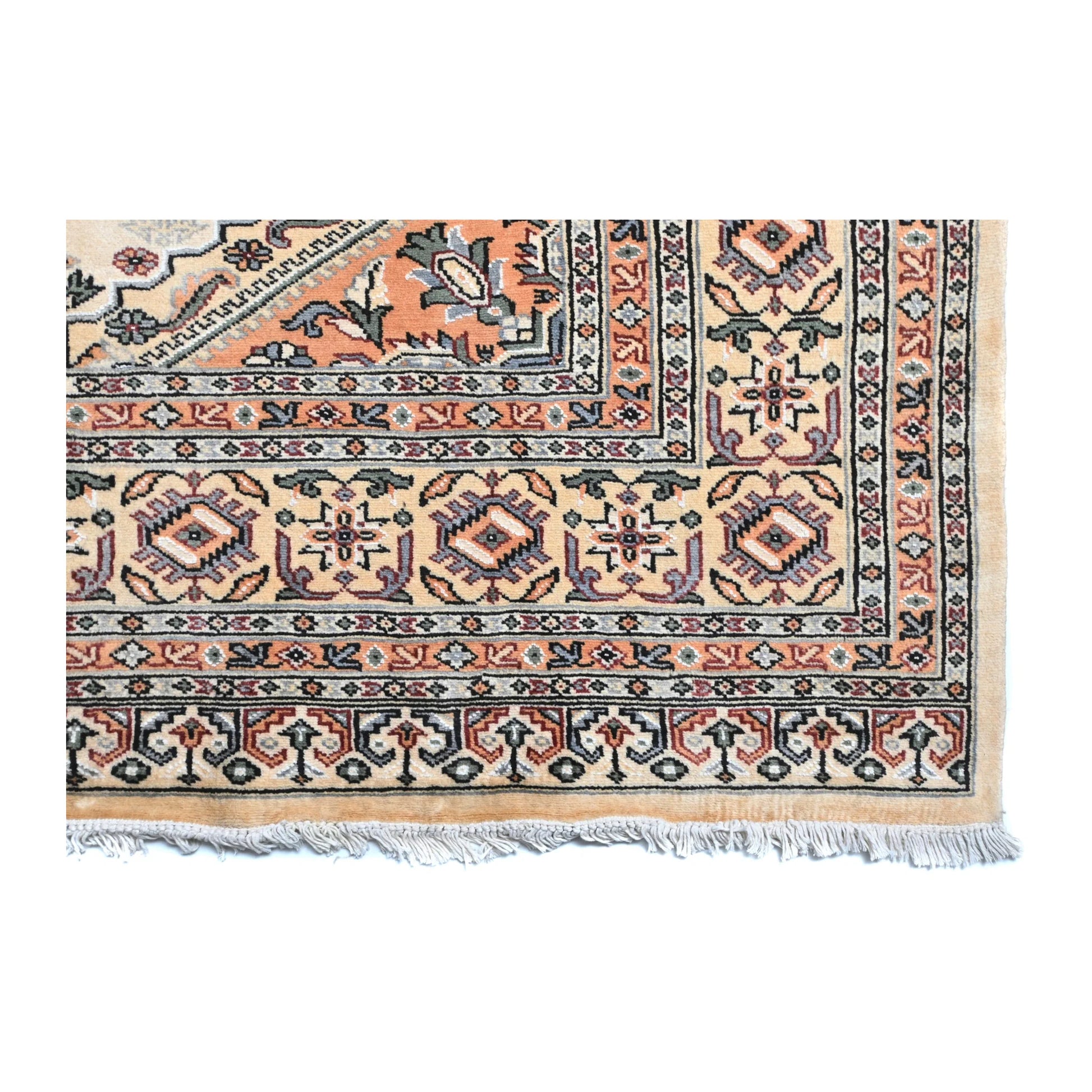 Close-up of Jaldar rug showing the patterned end border and visible fringe