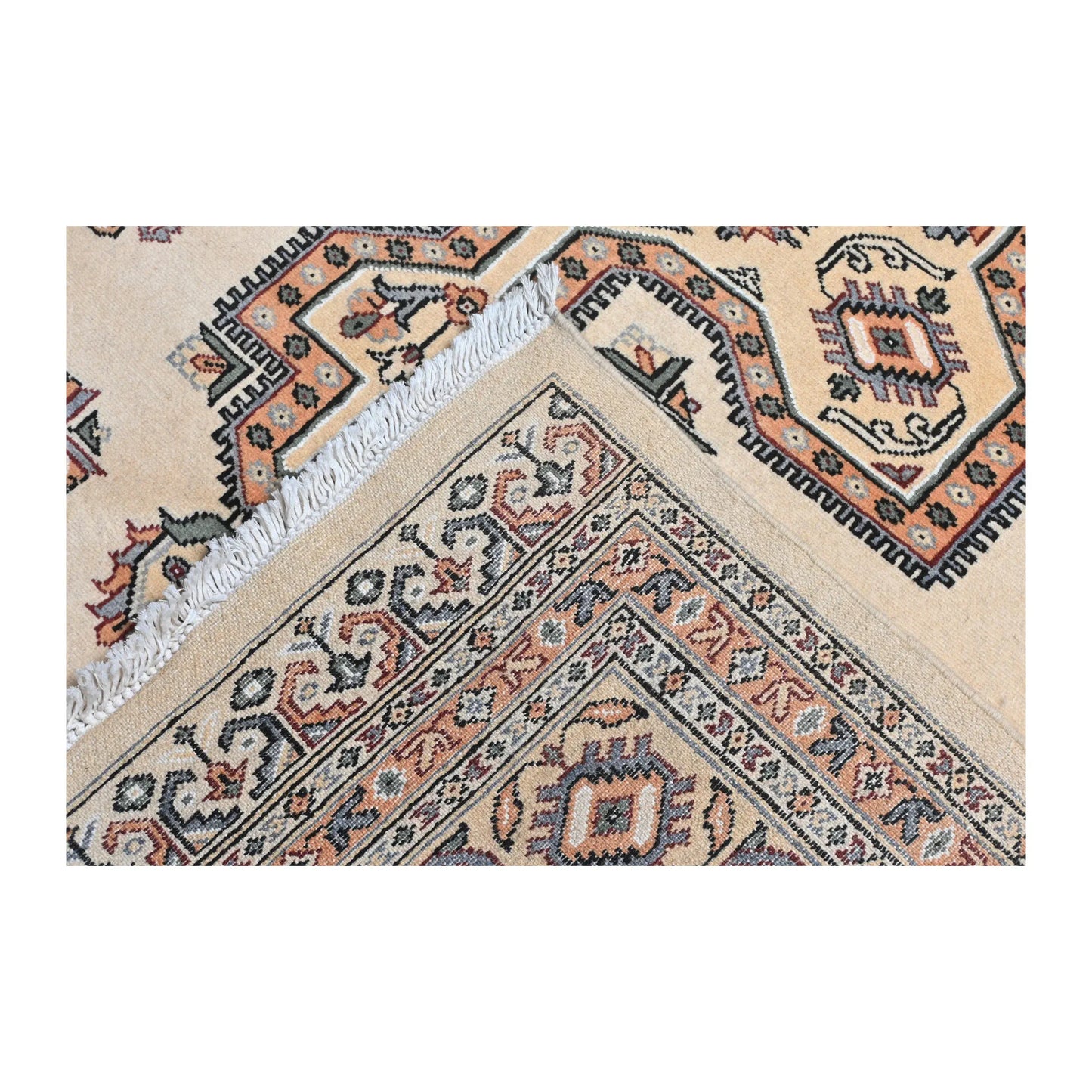 Folded corner detail of Jaldar rug showing the layered border, rug edge and geometric field pattern