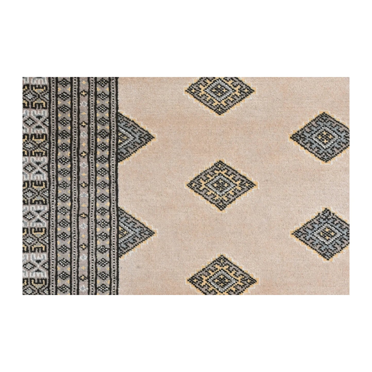 Close-up of Jaldar Silk Touch rug showing angular diamond guls across the beige field and the layered side border