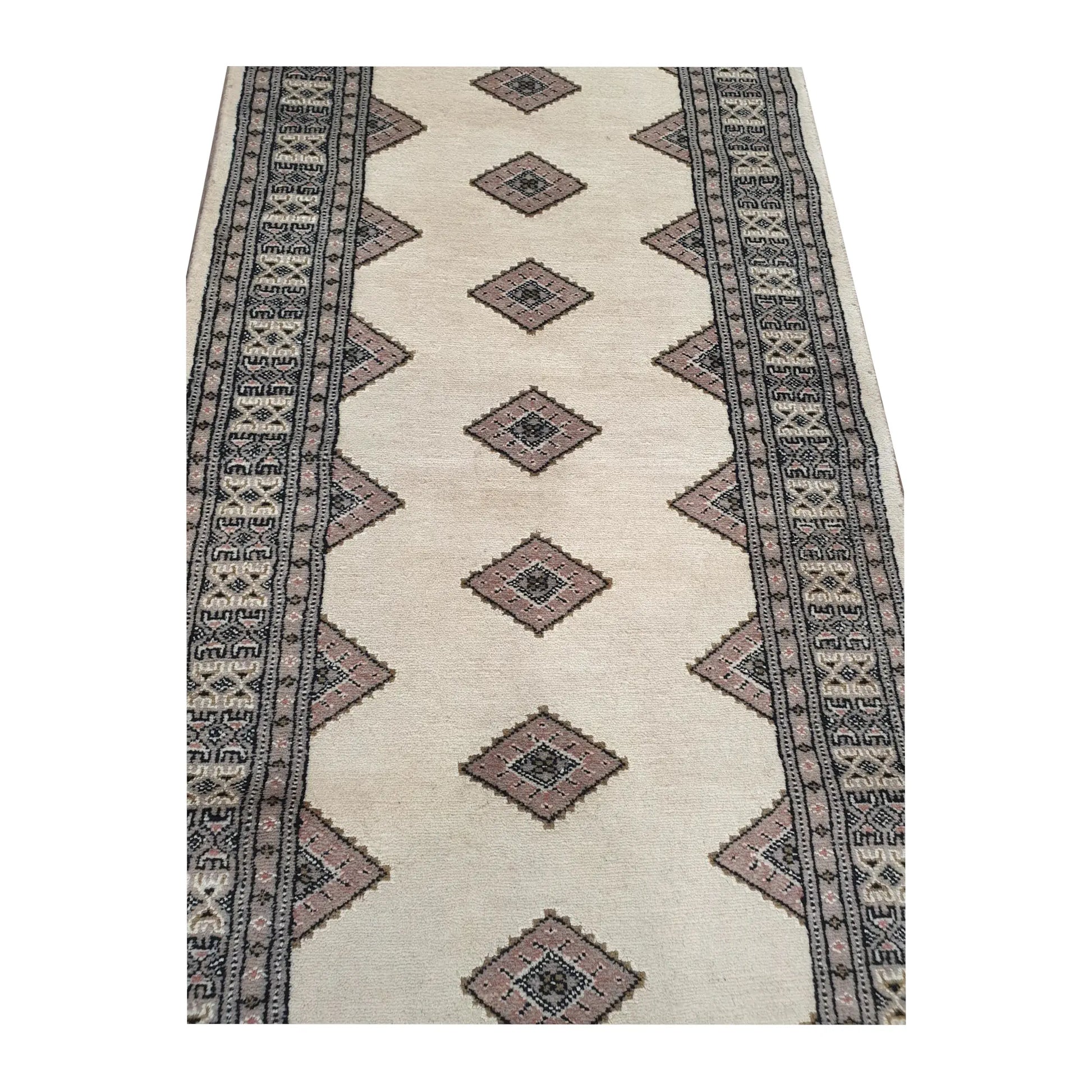 Close-up of Jaldar Silk Touch wool runner rug showing the repeating diamond-shaped gul pattern and detailed border