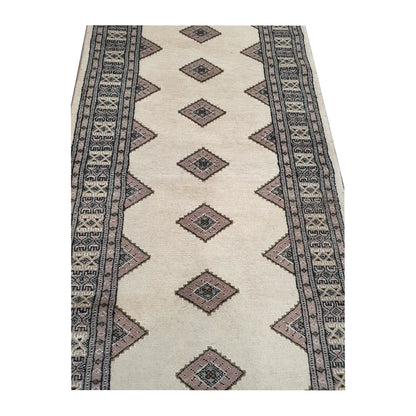 Close-up of Jaldar Silk Touch wool runner rug showing the repeating diamond-shaped gul pattern and detailed border