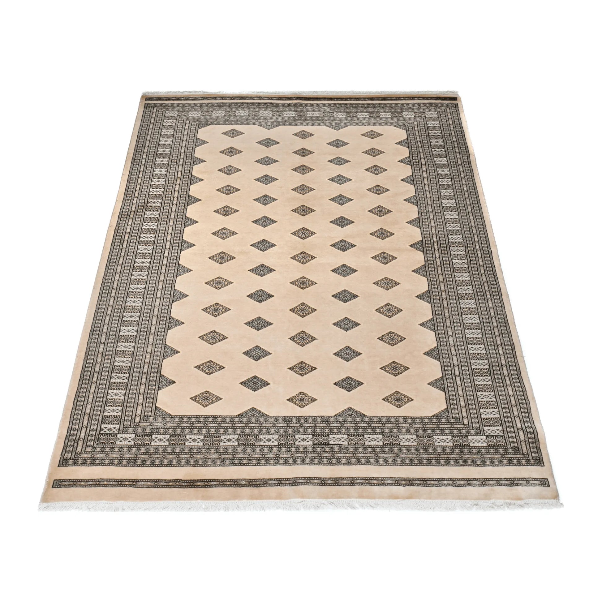 Angled full view of Jaldar Silk Touch wool and silk rug showing the beige field, repeating diamond guls and patterned borders
