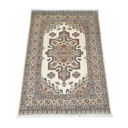Angled full view of Jaldar wool rug showing the beige field, central geometric medallion and patterned border