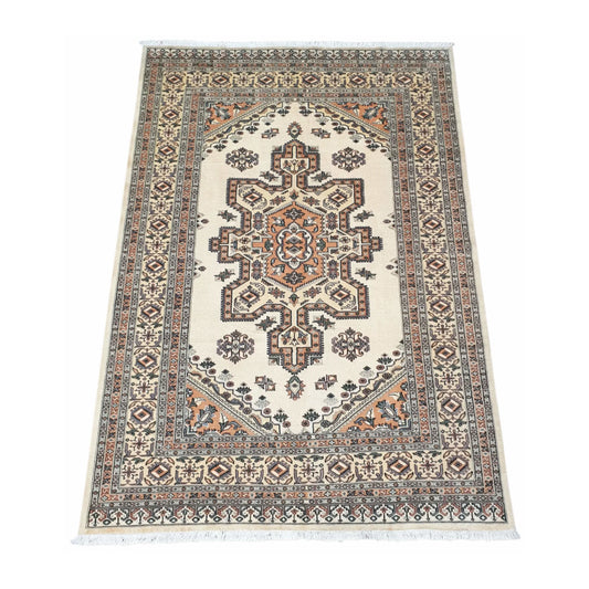 Angled full view of Jaldar wool rug showing the beige field, central geometric medallion and patterned border