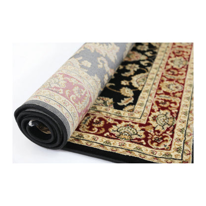 Rolled edge detail of Julian 90500 Black Red traditional rug showing backing, binding and patterned polypropylene pile
