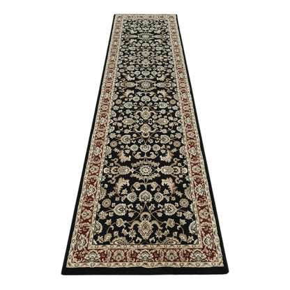 Full view of Julian black machine-made runner rug with floral motifs and red border