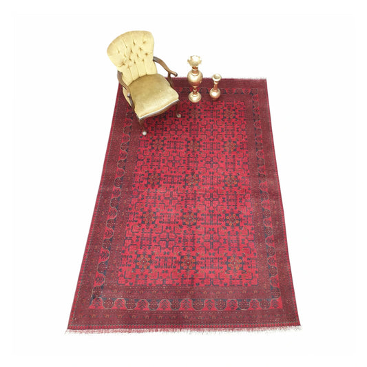 Angled full view of Khal Mohammadi wool rug 294 x 198 cm with deep red field and traditional Afghan geometric border