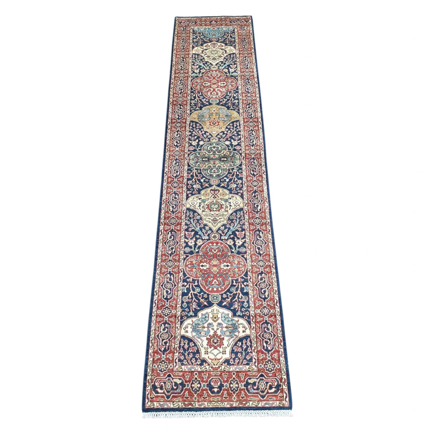 Khurjeen hand-knotted wool runner rug 352 x 81 cm shown in full view with red and navy geometric medallion design