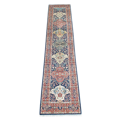 Khurjeen hand-knotted wool runner rug 352 x 81 cm shown in full view with red and navy geometric medallion design