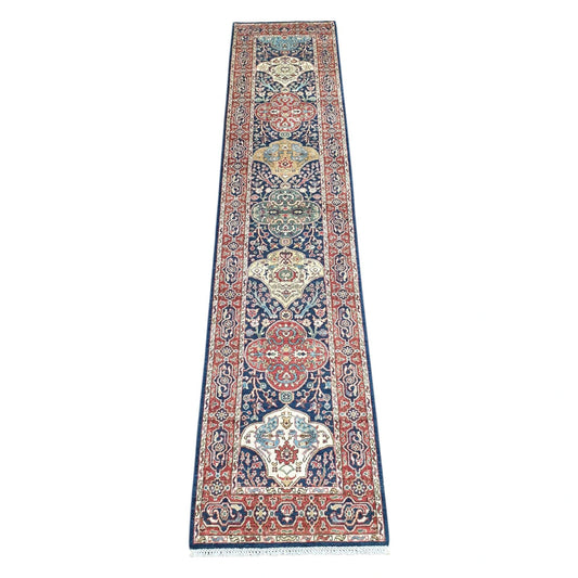 Khurjeen hand-knotted wool runner rug 352 x 81 cm shown in full view with red and navy geometric medallion design