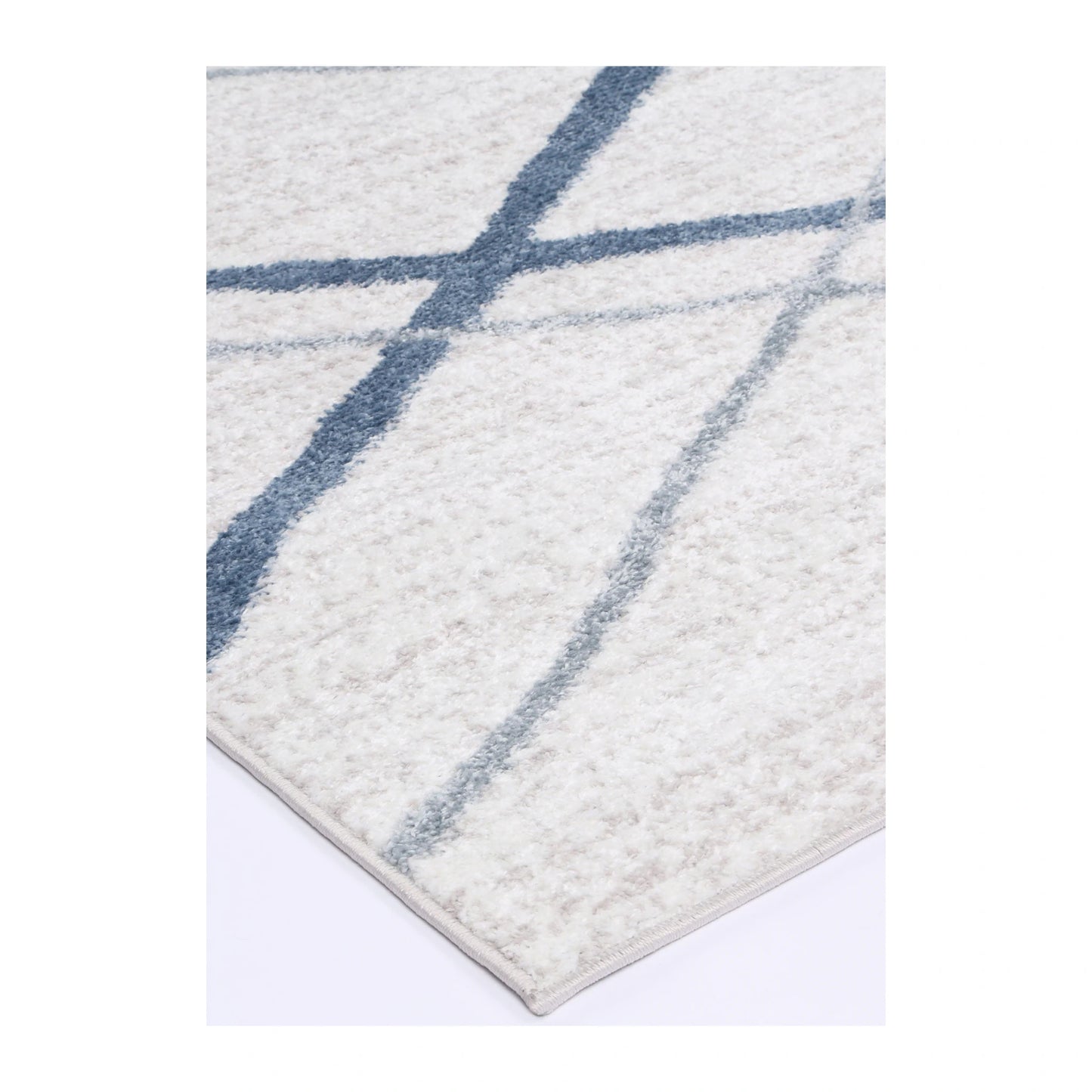 Corner detail of Kimberley 2 Blue Lattice rug showing bound edge, textured pile and modern geometric pattern, 230 x 160 cm