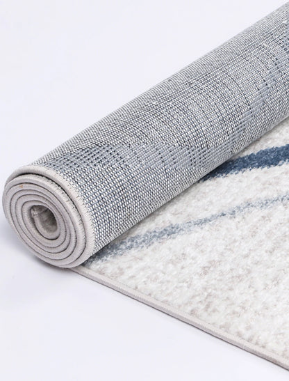 Rolled edge detail of Kimberley 2 Blue Lattice rug showing backing, binding and polypropylene pile texture, 230 x 160 cm