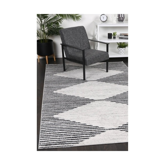 Kimberley 3 Diamond Charcoal rug styled with chair and indoor décor, showing modern charcoal white diamond design, 230 x 160 cm