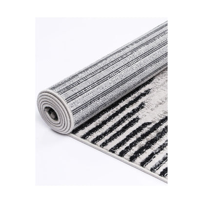 Rolled edge detail of Kimberley 3 Diamond Charcoal rug showing backing, binding and patterned heatset polypropylene pile, 230 x 160 cm