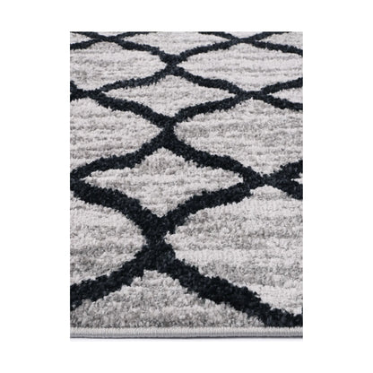 Edge detail of Kimberley 5 Repeat Charcoal rug showing heatset polypropylene pile, grey surface and charcoal pattern, 230 x 160 cm