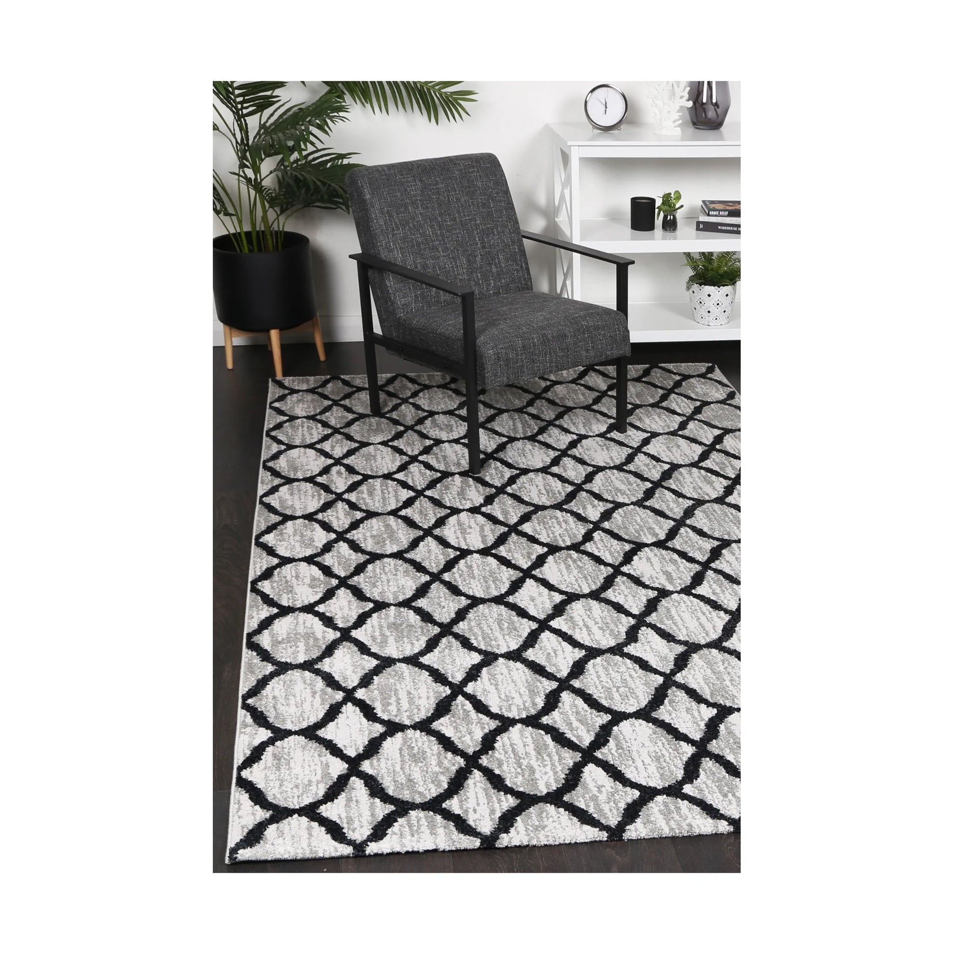 Kimberley 5 Repeat Charcoal rug styled with chair and indoor décor, showing modern charcoal grey lattice design, 230 x 160 cm
