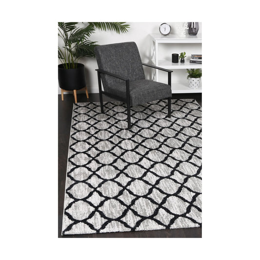 Kimberley 5 Repeat Charcoal rug styled with chair and indoor décor, showing modern charcoal grey lattice design, 230 x 160 cm