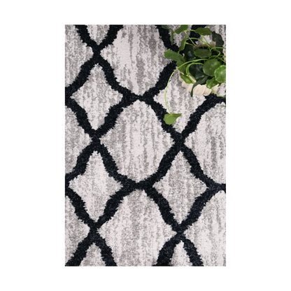 Styled close-up of Kimberley 5 Repeat Charcoal rug showing textured pile and repeating charcoal lattice pattern, 230 x 160 cm
