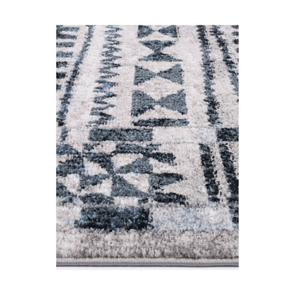 Edge detail of Kimberley 7 Aztec Blue rug showing textured pile, blue grey pattern and bound edge, 230 x 160 cm