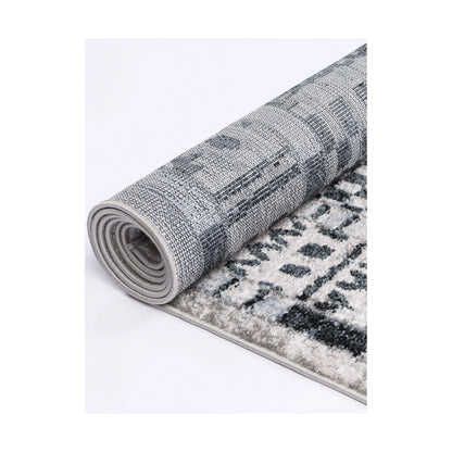 Rolled edge detail of Kimberley 7 Aztec Blue rug showing backing, binding and patterned heatset polypropylene pile, 230 x 160 cm