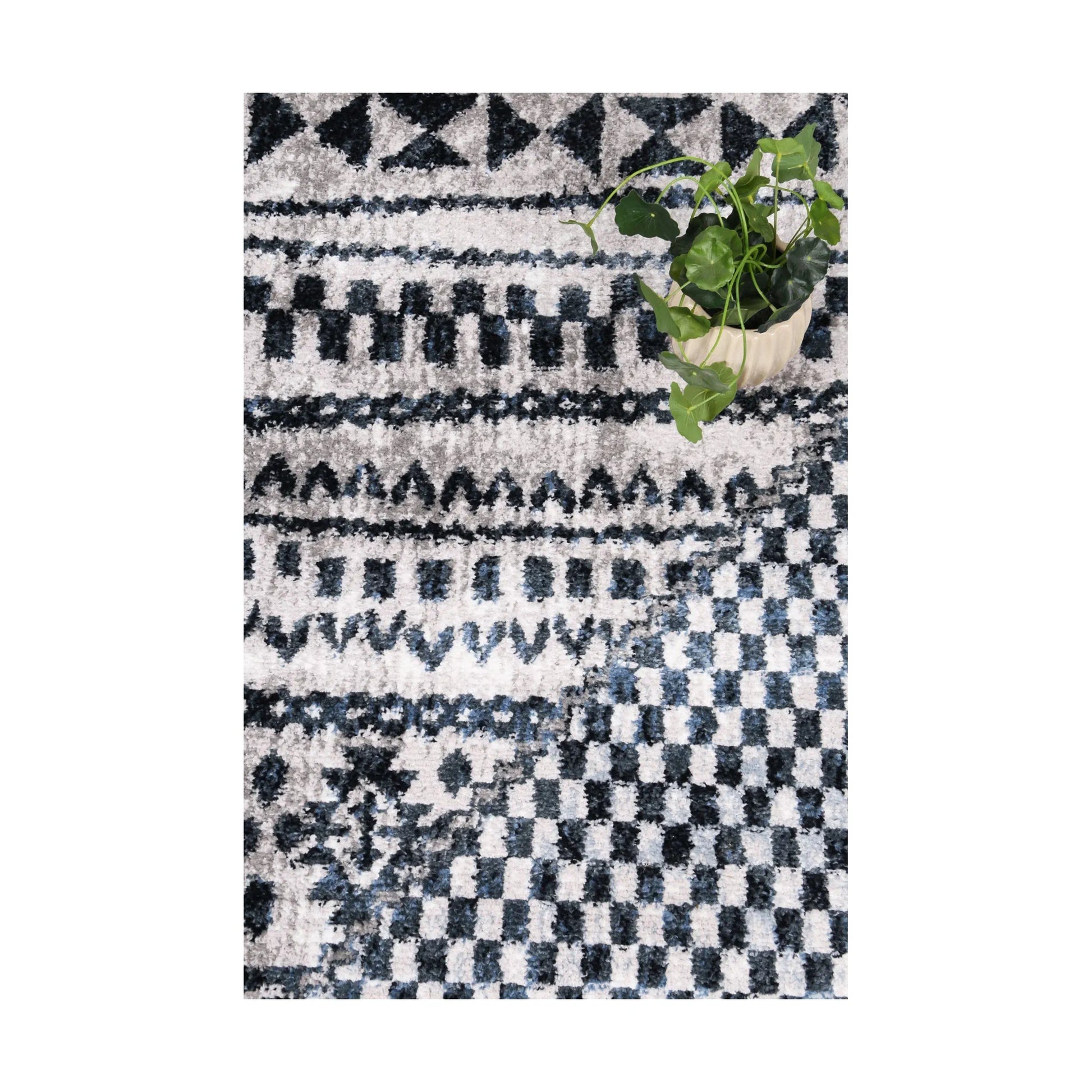Styled close-up of Kimberley 7 Aztec Blue rug showing blue white geometric motifs and heatset polypropylene pile, 230 x 160 cm