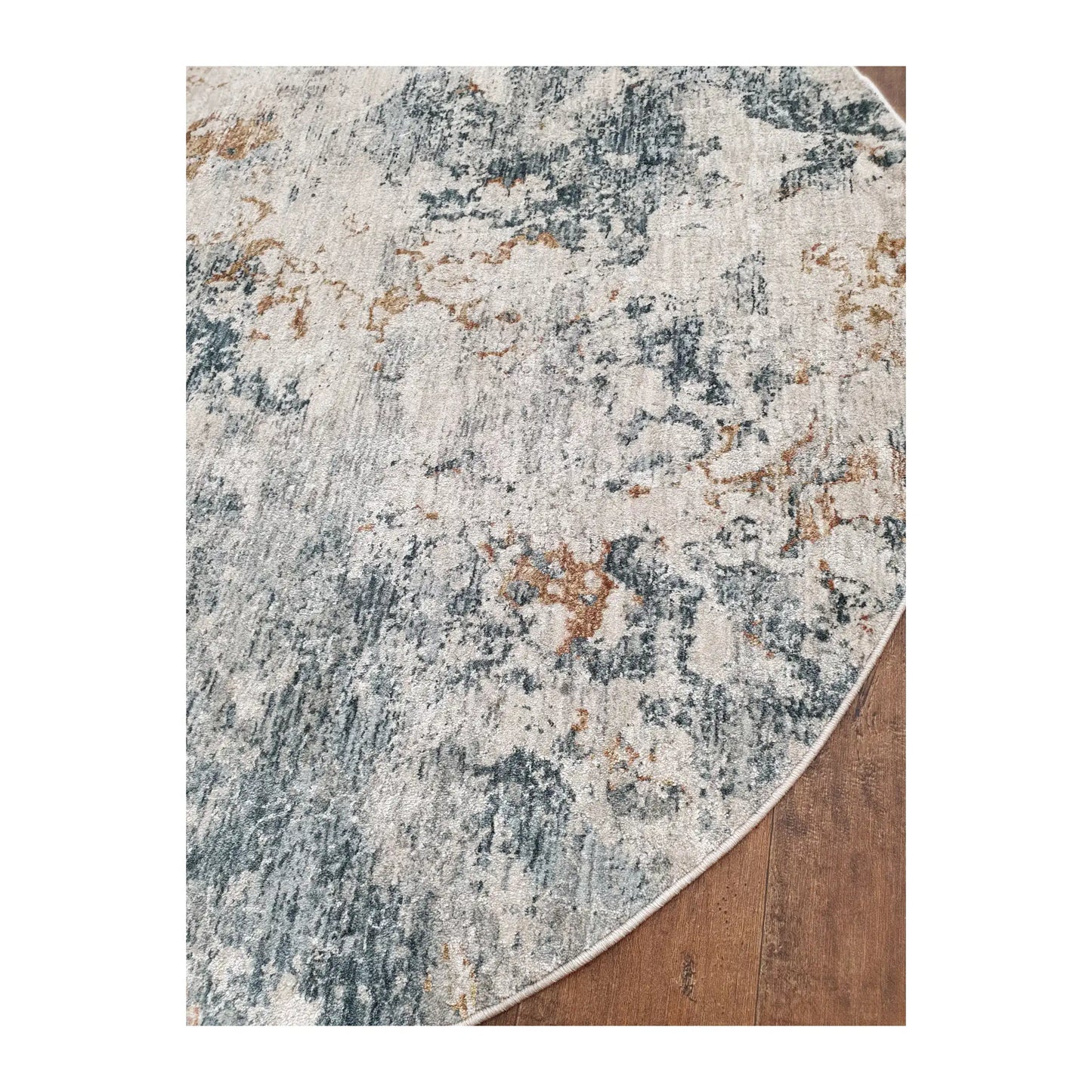 Angled detail of light gray round rug showing abstract pattern and edge finish, 160 cm