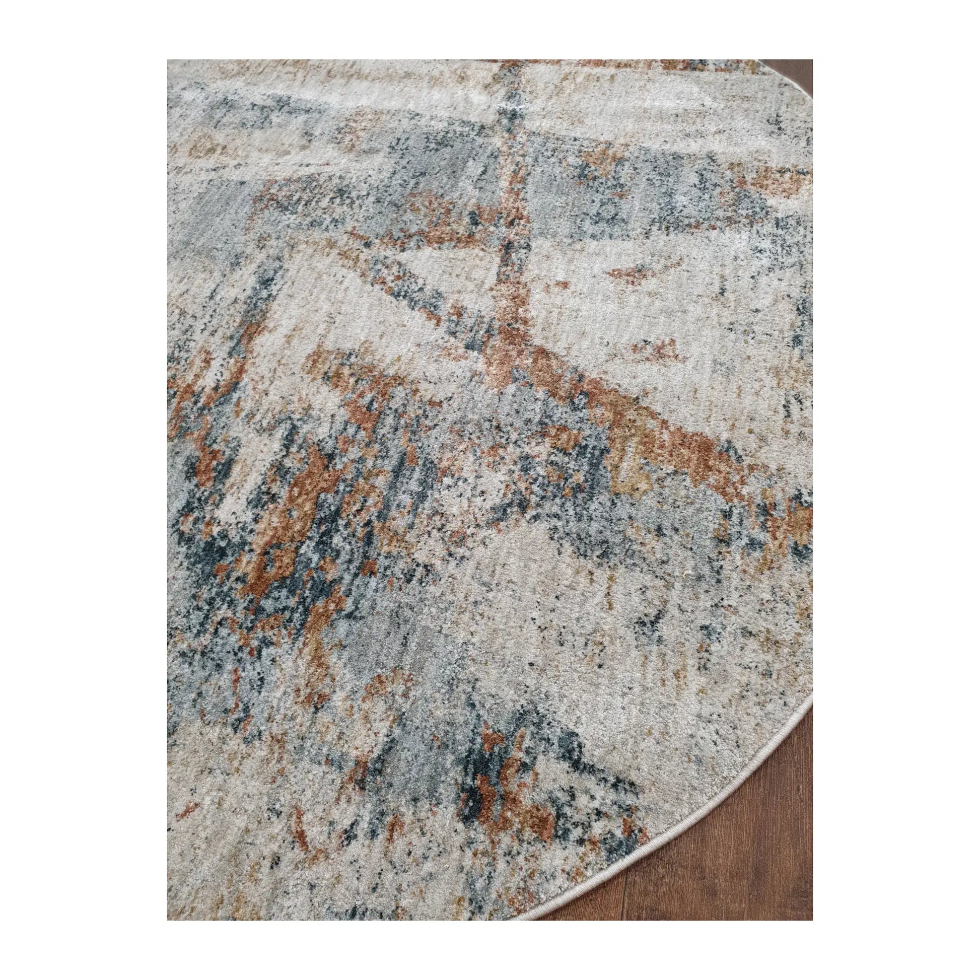 Low-angle close-up of light grey round rug showing surface texture and abstract brushstroke design, 160 cm