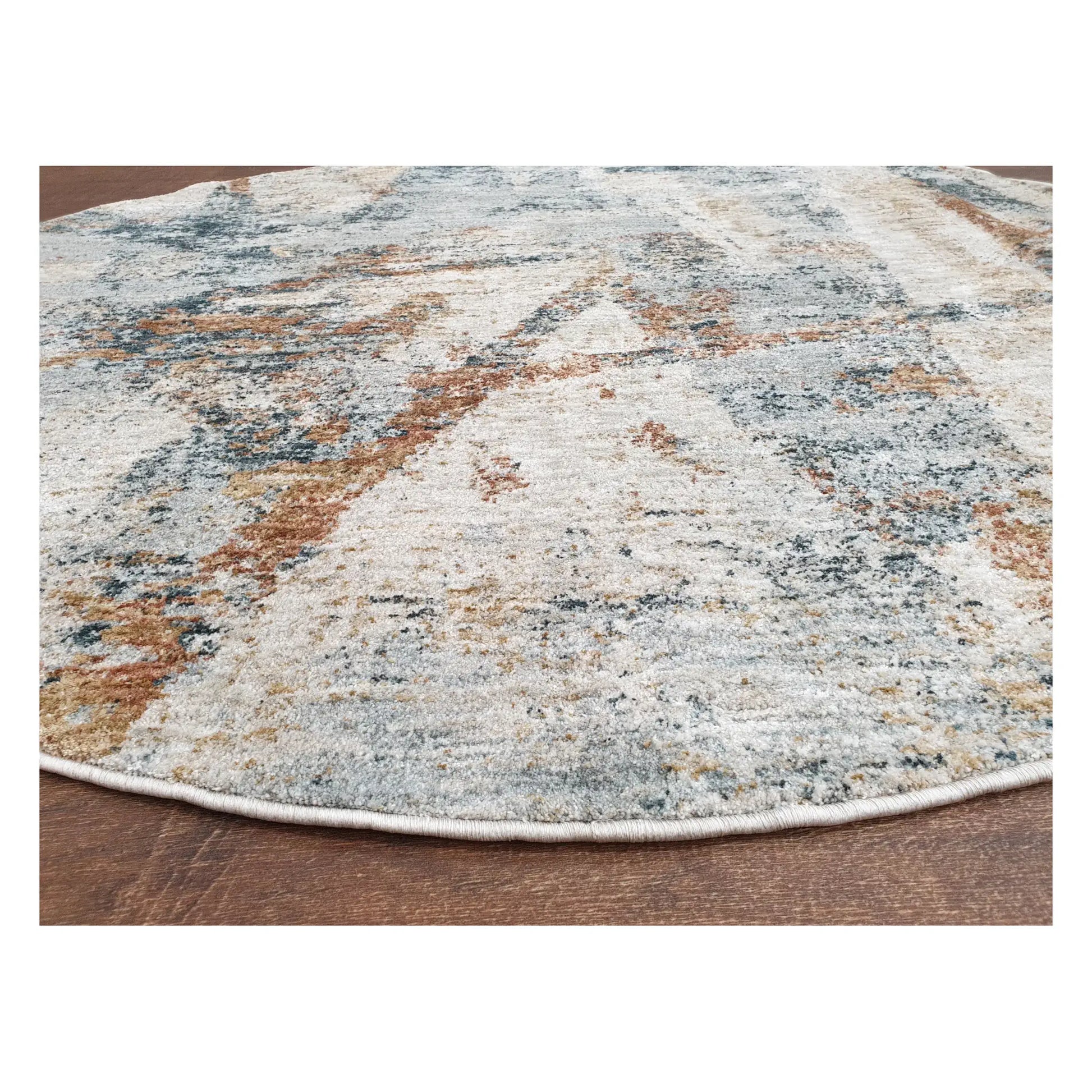 Angled detail of light grey round rug showing abstract pattern and edge finish, 160 cm