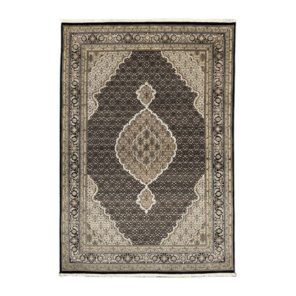 Full view of Mahi Tabriz hand-knotted wool rug with deep brown-black field, ornate central medallion and layered beige borders, 295 x 196 cm