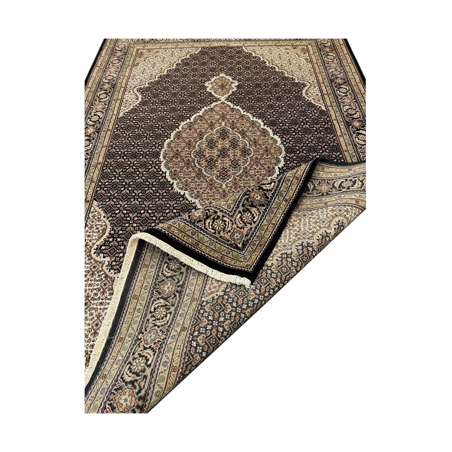 Folded-corner detail of Mahi Tabriz rug showing the patterned field, layered border and reverse weave