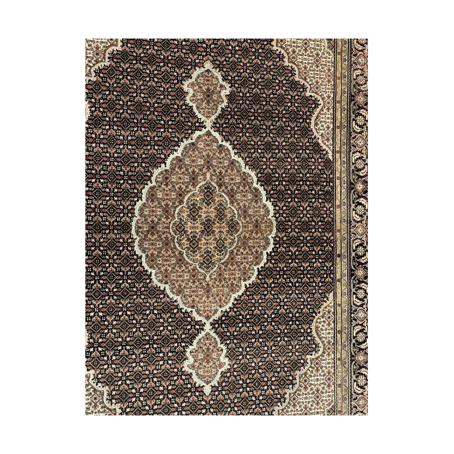 Detail of Mahi Tabriz rug showing the central medallion, dense Mahi field pattern and layered side border