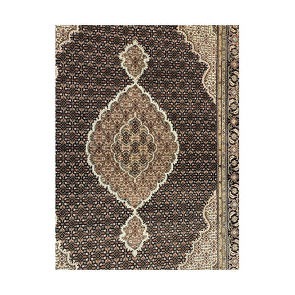Detail of Mahi Tabriz rug showing the central medallion, dense Mahi field pattern and layered side border