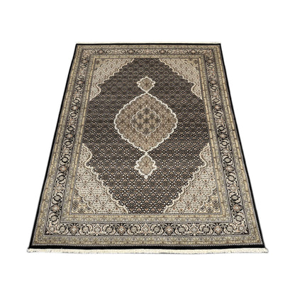 Angled full view of Mahi Tabriz wool rug showing the central medallion, dense patterned field and floral borders