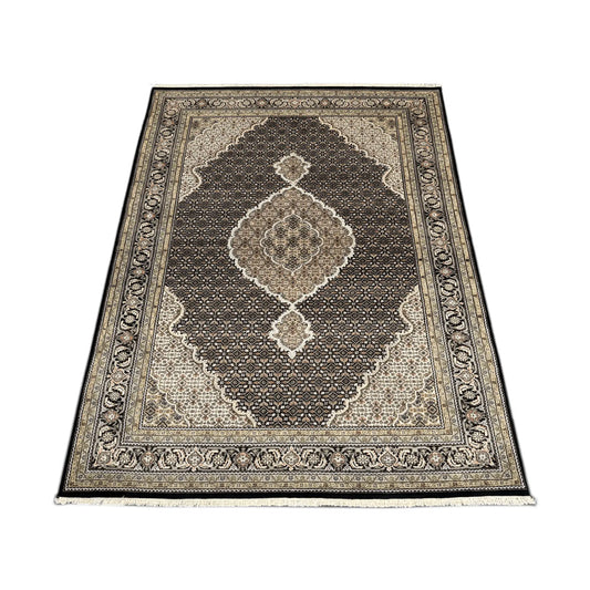 Angled full view of Mahi Tabriz wool rug showing the central medallion, dense patterned field and floral borders