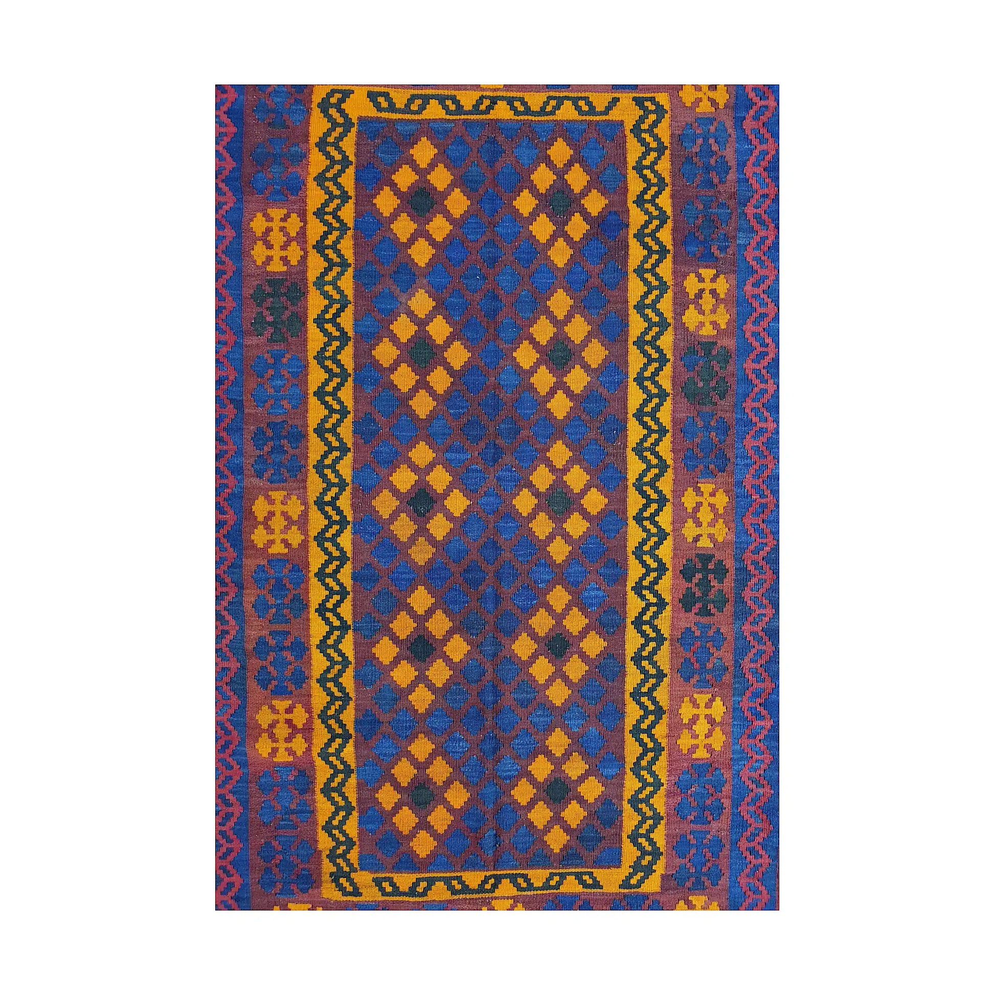 Close-up of Mamina Kilim wool rug showing purple blue geometric field with yellow, orange and red border details