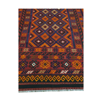 Close detail of Mamina Kilim wool rug showing diamond lattice field, yellow border accents and tribal geometric motifs