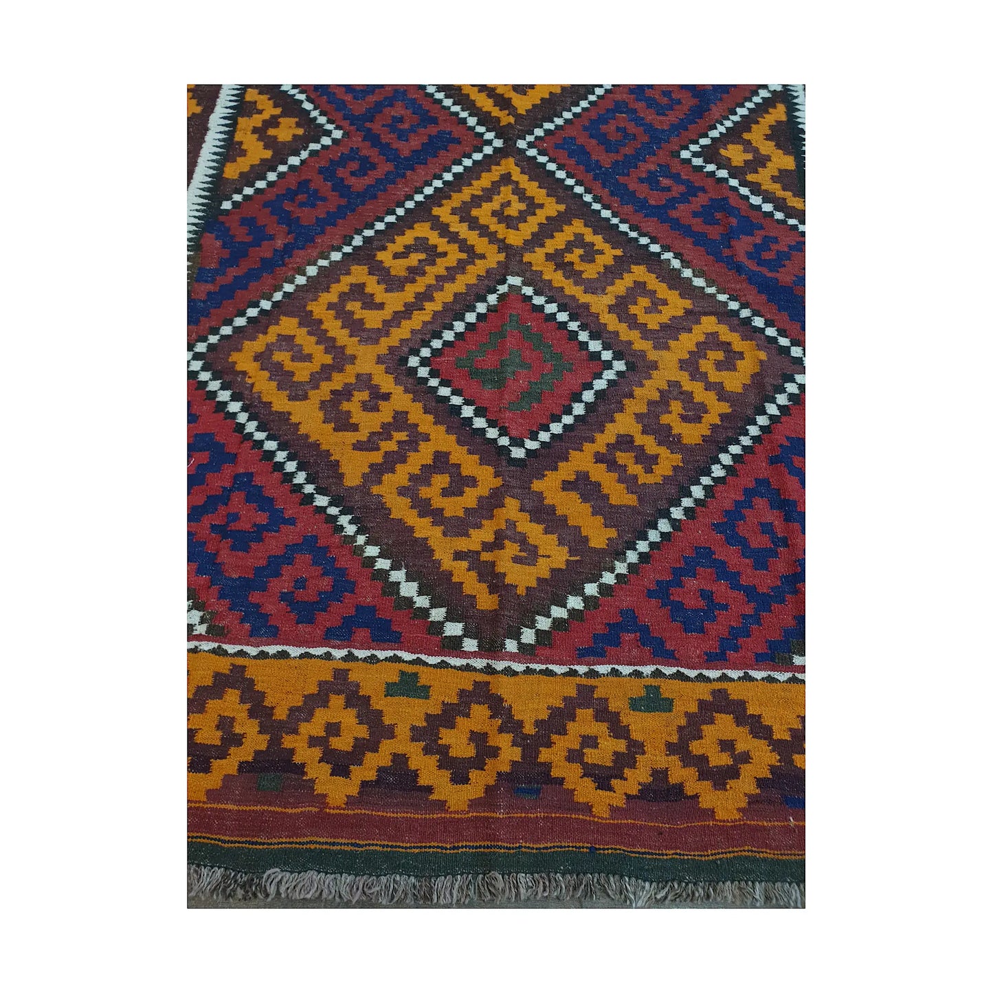 Diamond medallion and border detail of Mamina Kilim wool rug showing mustard geometric field and dark tribal motifs