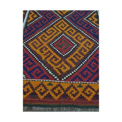 Diamond medallion and border detail of Mamina Kilim wool rug showing mustard geometric field and dark tribal motifs