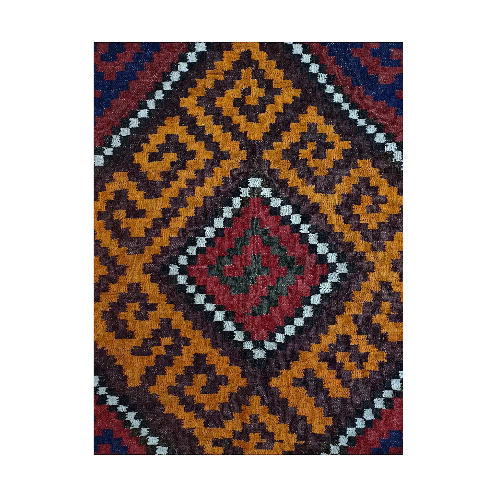 Close-up of Mamina Kilim wool rug showing mustard diamond medallion pattern with burgundy, navy and ivory accents