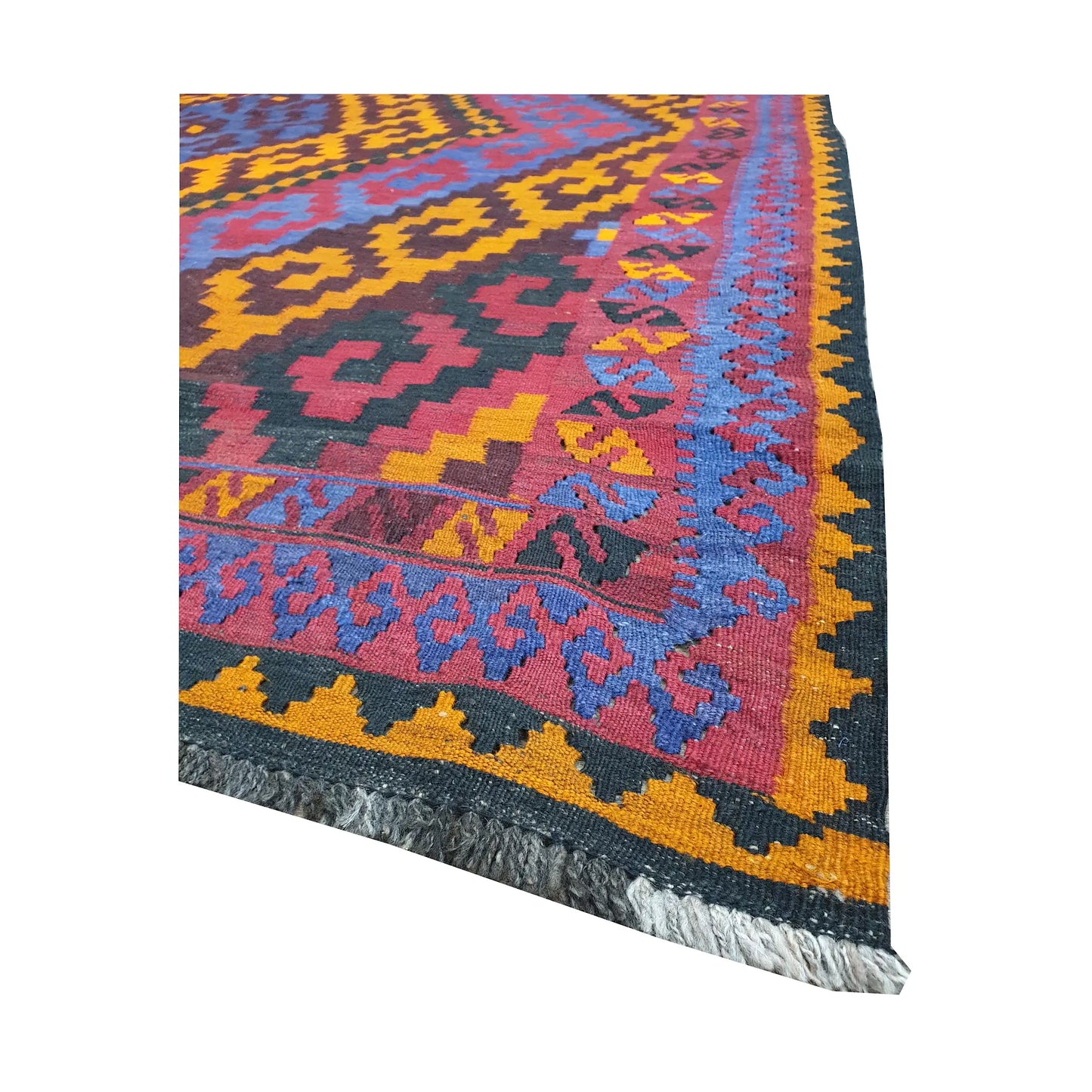 Angled fringe and border detail of Mamina Kilim wool rug showing purple, gold, blue and magenta flatwoven pattern