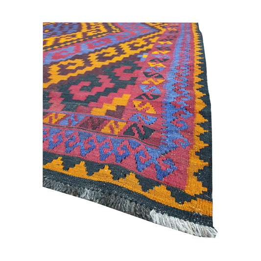 Angled fringe and border detail of Mamina Kilim wool rug showing purple, gold, blue and magenta flatwoven pattern