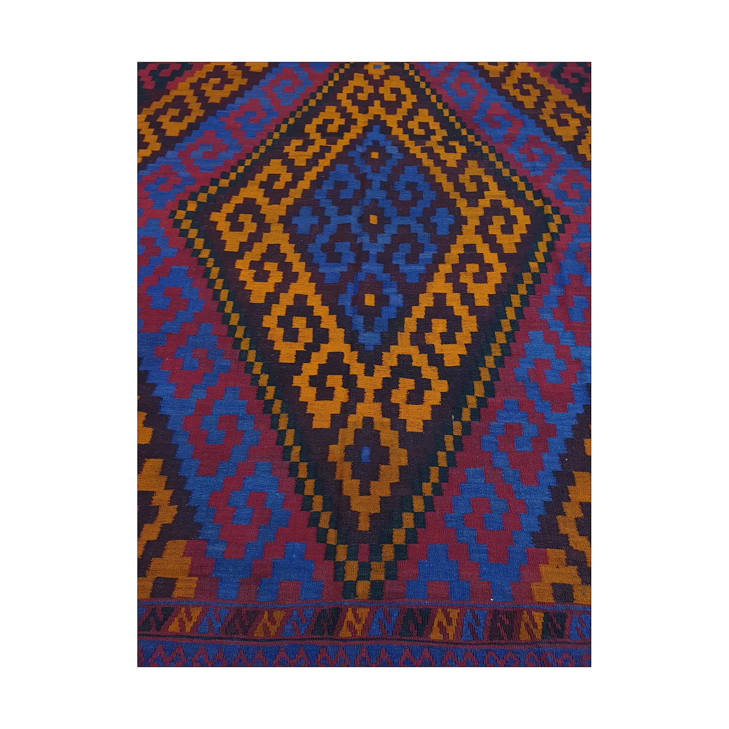 Close-up of Mamina Kilim wool rug showing gold diamond medallion pattern with purple, blue and black details