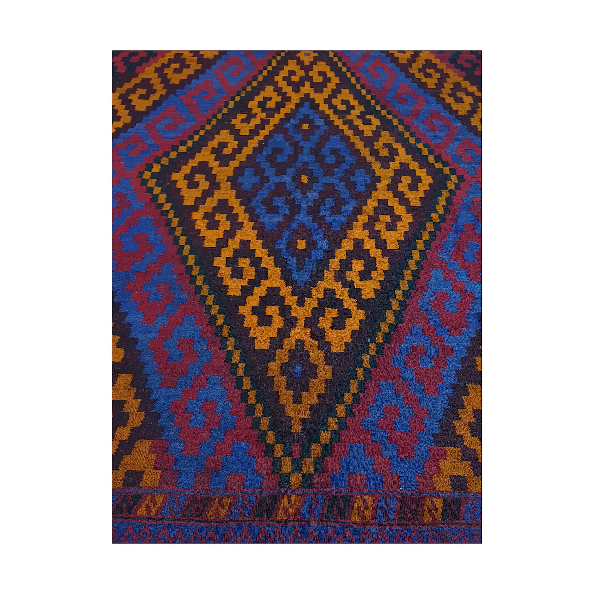 Close-up of Mamina Kilim wool rug showing gold diamond medallion pattern with purple, blue and black details
