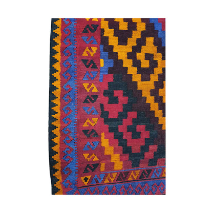 Side border detail of Mamina Kilim wool rug showing gold, magenta, purple and black tribal geometric motifs