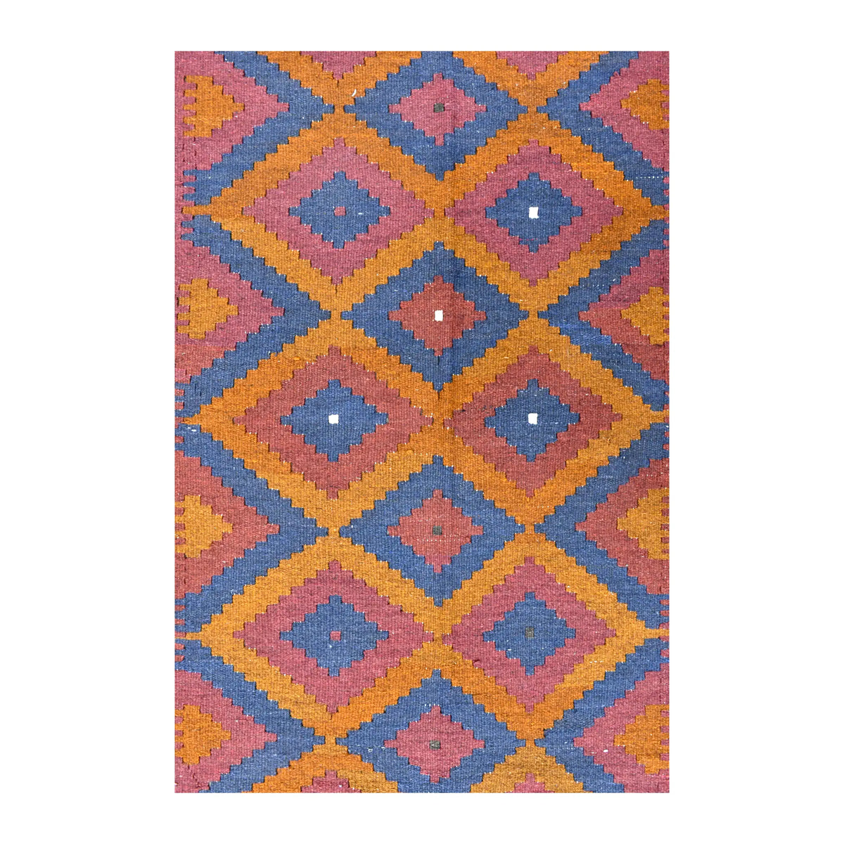 Close-up of Mamina kilim showing stepped slate-blue diamonds, burnt orange bands, muted red centres and small ivory accents
