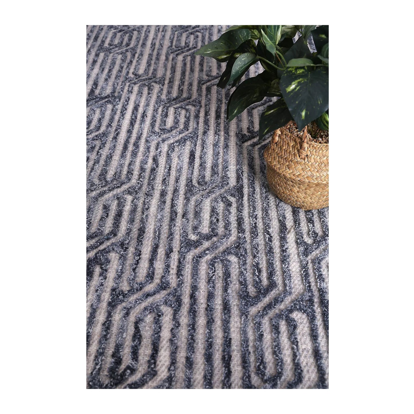 Lifestyle view of Marbella Almeria blue-grey wool rug with charcoal geometric pattern, 230 x 160 cm