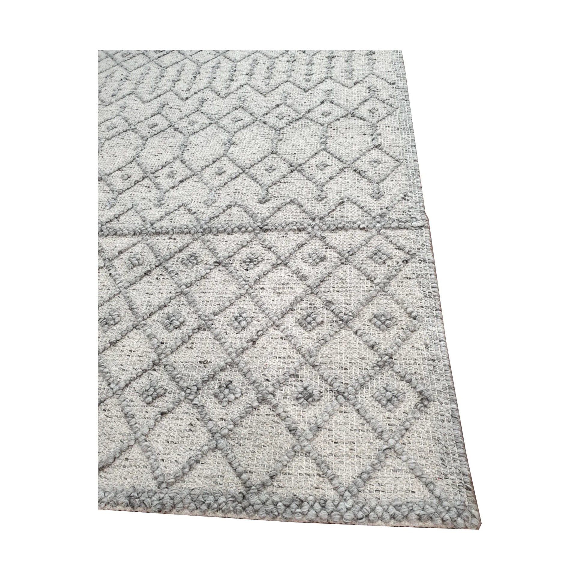 Border and edge detail of modern grey wool rug showing geometric diamond pattern and woven texture