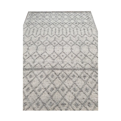 Close-up of modern grey geometric wool rug showing ivory diamond pattern and soft woven surface