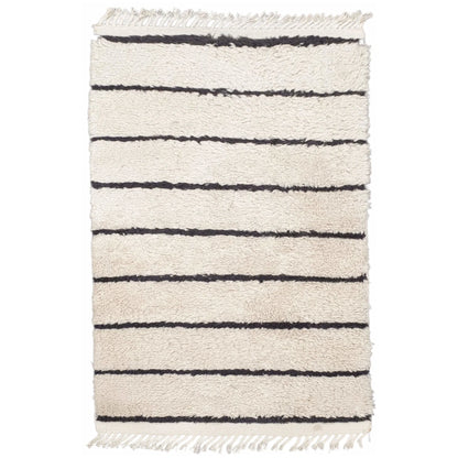 Full view of Moroccan Design hand-knotted wool rug with cream field, black horizontal stripes and fringe ends, 165 x 90 cm