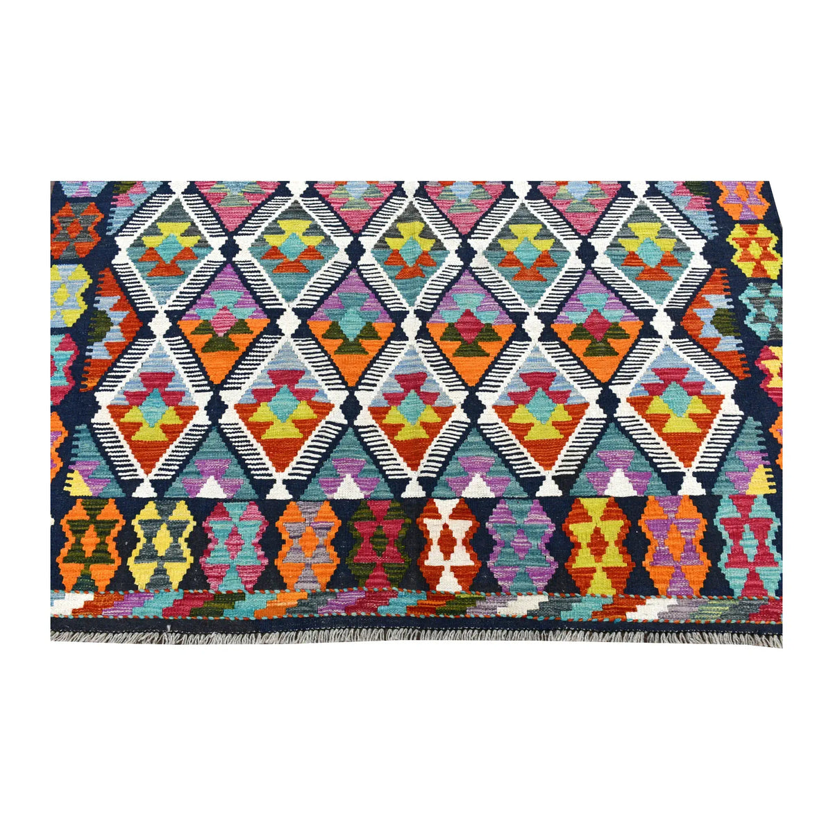 Fringe-end detail of Afghan Chobi kilim showing colourful diamonds above a navy border filled with larger angular motifs